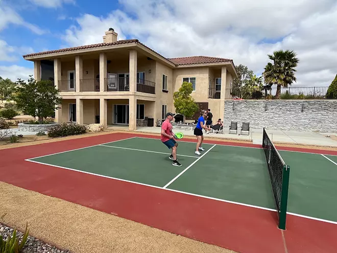 Diane playing a pickleball game on retreat